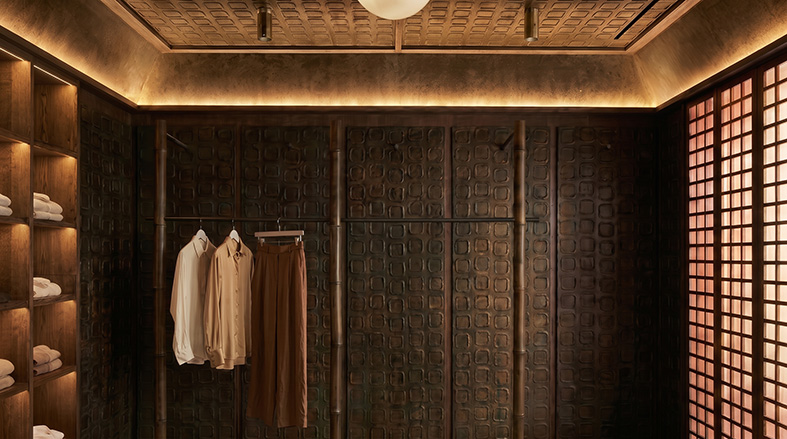 A Di Canapa interior: hemp acoustic panelling lining a warm, low-lit fitting room.